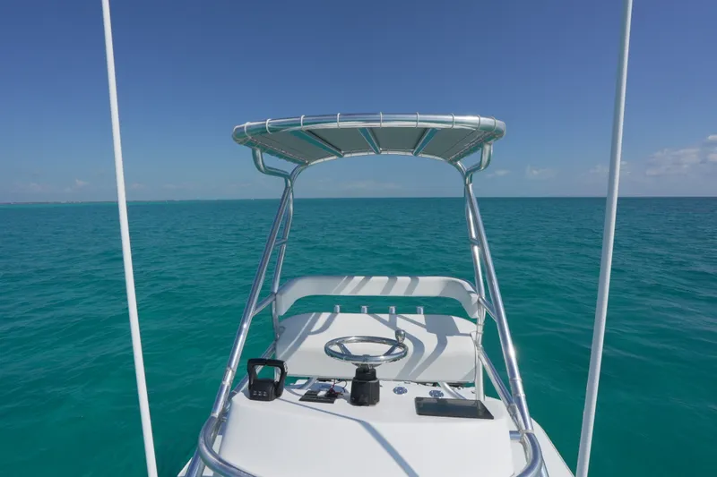 Slide: The Image of Freeman 42 boat helm with ocean view, 2024 model, clear blue skies. - 41