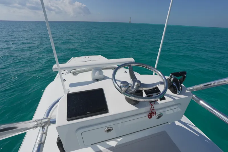 Slide: The Image of 2024 Freeman 42 boat helm with steering wheel and ocean view. - 42