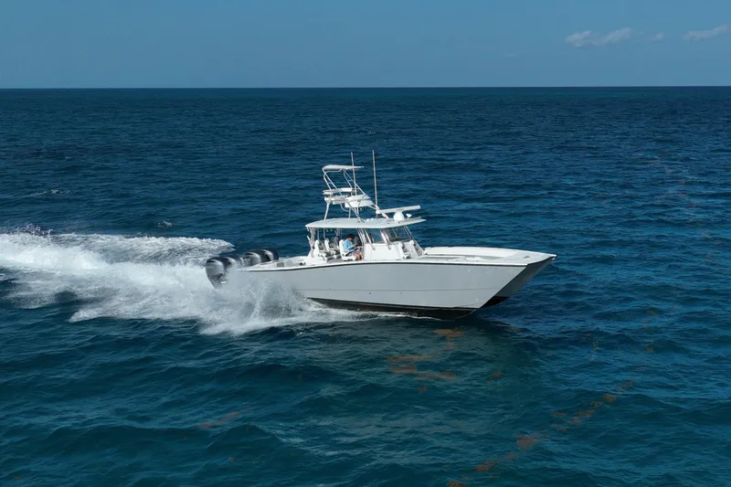 Slide: The Image of 2024 Freeman 42 boat cruising on open ocean waters under clear blue sky. - 25