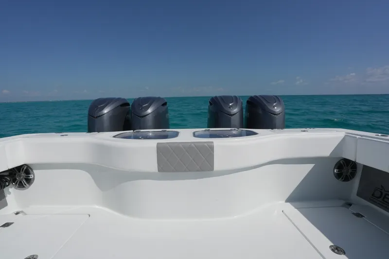 Slide: The Image of 2024 Freeman 42 boat with four engines on open sea under clear blue sky. - 46