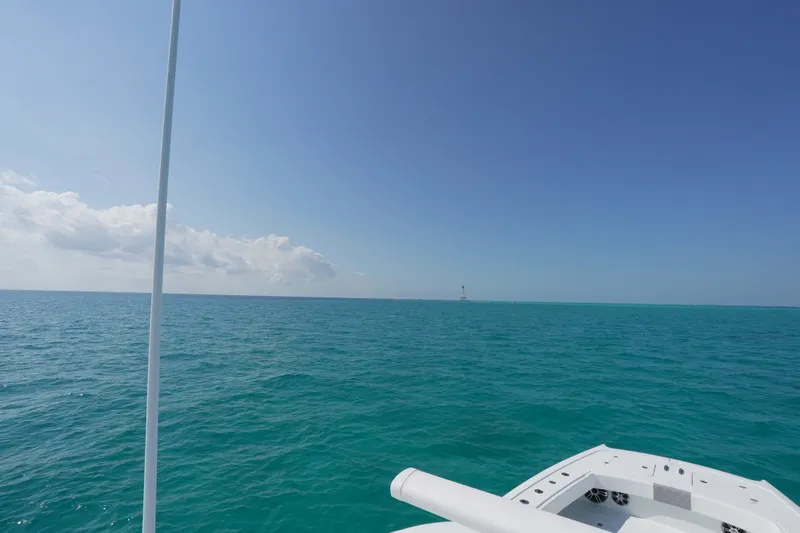 Slide: The Image of Freeman 42 boat on turquoise ocean under clear blue sky, 2024 model. - 38