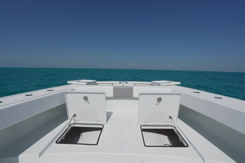 Slide: The Image of 2024 Freeman 42 boat deck with open storage compartments on calm ocean. - 37
