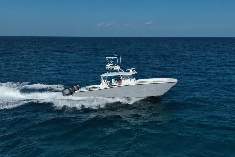 Slide: The Image of 2024 Freeman 42 boat cruising on open ocean under clear blue sky. - 28