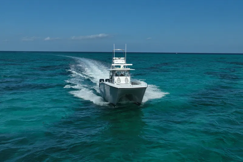 Slide: The Image of 2024 Freeman 42 boat cruising on clear turquoise ocean waters. - 15