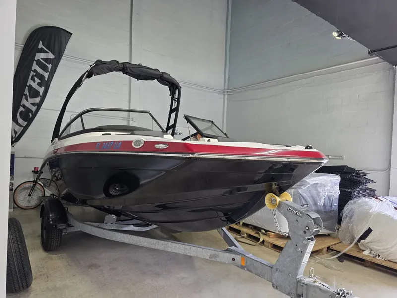 The Image of A 2025 Yamaha AR195 boat on a trailer in a storage area. - 1