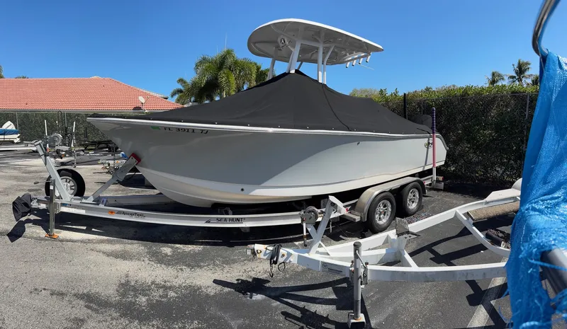 The Image of A 2022 Sea Hunt Ultra 234 CC boat on a trailer, covered with a black tarp. - 1