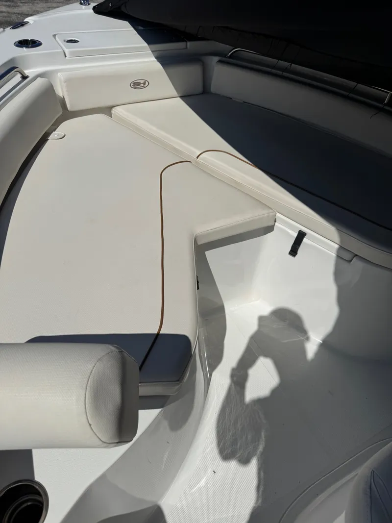 Slide: The Image of The image shows the bow area of a 2022 Sea Hunt Ultra 234 CC boat with cushioned seating. - 5