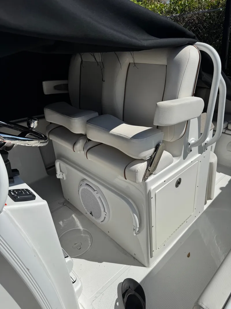 Slide: The Image of The image shows the cockpit seating of a 2022 Sea Hunt Ultra 234 CC boat. - 4