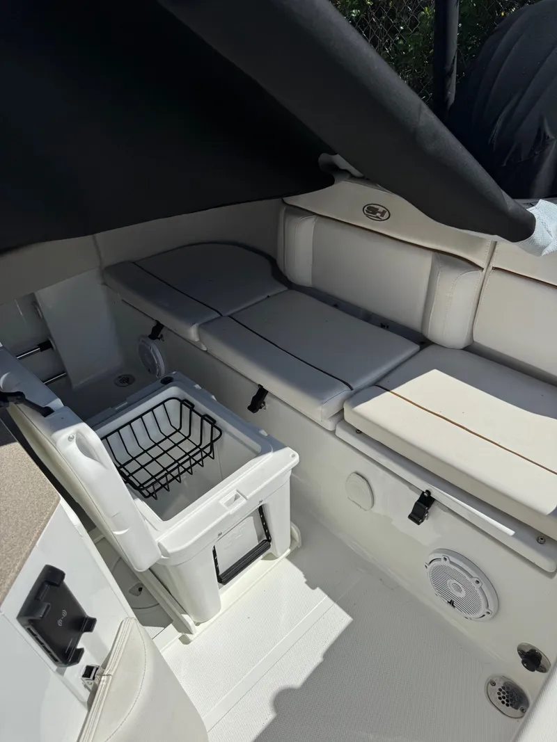 Slide: The Image of Interior of a Sea Hunt Ultra 234 CC boat with white upholstery and storage space. - 3