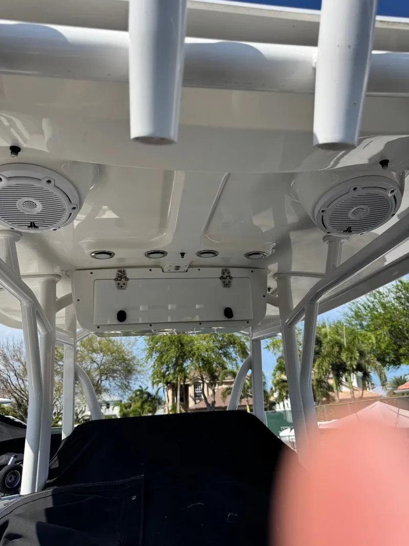 Slide: The Image of The image shows the T-top of a Sea Hunt Ultra 234 CC boat with speakers and mounts. - 6
