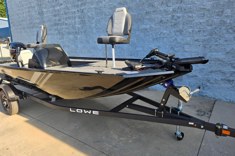 Slide: The Image of 2027 Lowe Skorpion 16 fishing boat on trailer, featuring modern seating and equipment. - 4