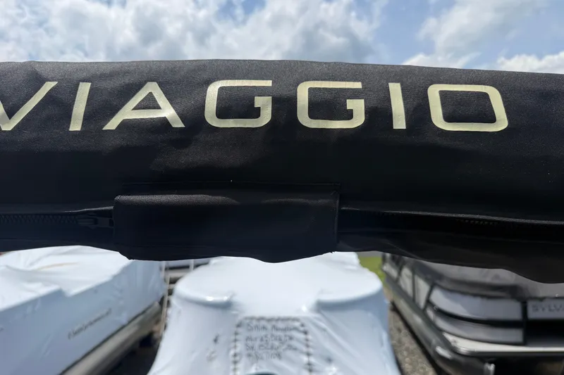 Slide: The Image of Black Viaggio cover on a 2027 x22u model boat under cloudy sky. - 21