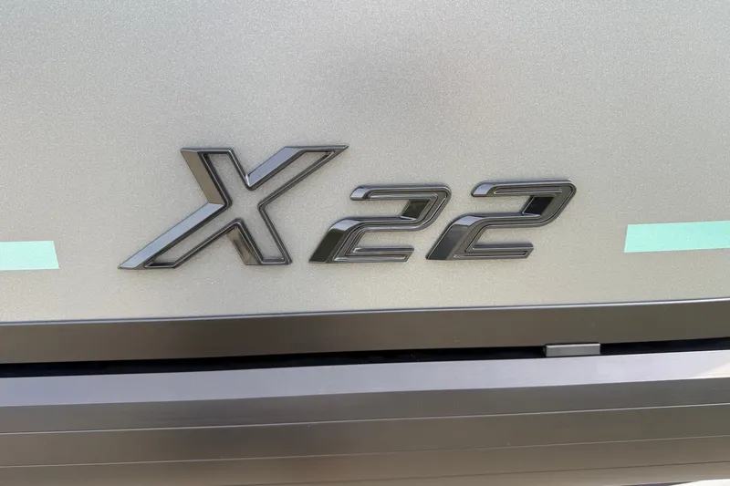 Slide: The Image of Viaggio x22u 2027 model emblem on metallic surface. - 32