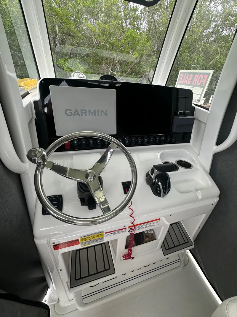 Slide: The Image of The image shows the helm of a Sea Hunt Ultra 255SE boat with a Garmin display. - 6