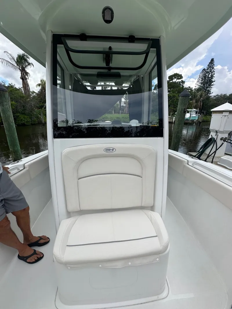 Slide: The Image of The image shows the interior of a Sea Hunt Ultra 255SE boat with a cushioned seat. - 8