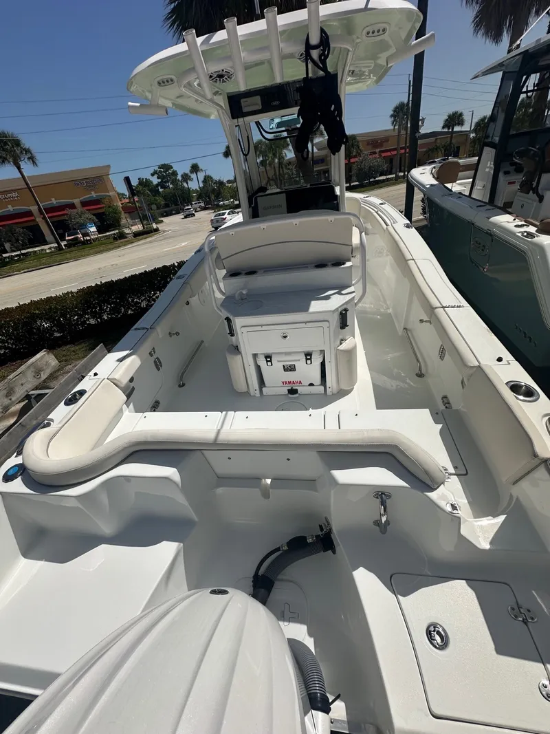 Slide: The Image of The image shows a 2025 Sea Hunt Ultra 255SE boat with a spacious, white deck. - 4