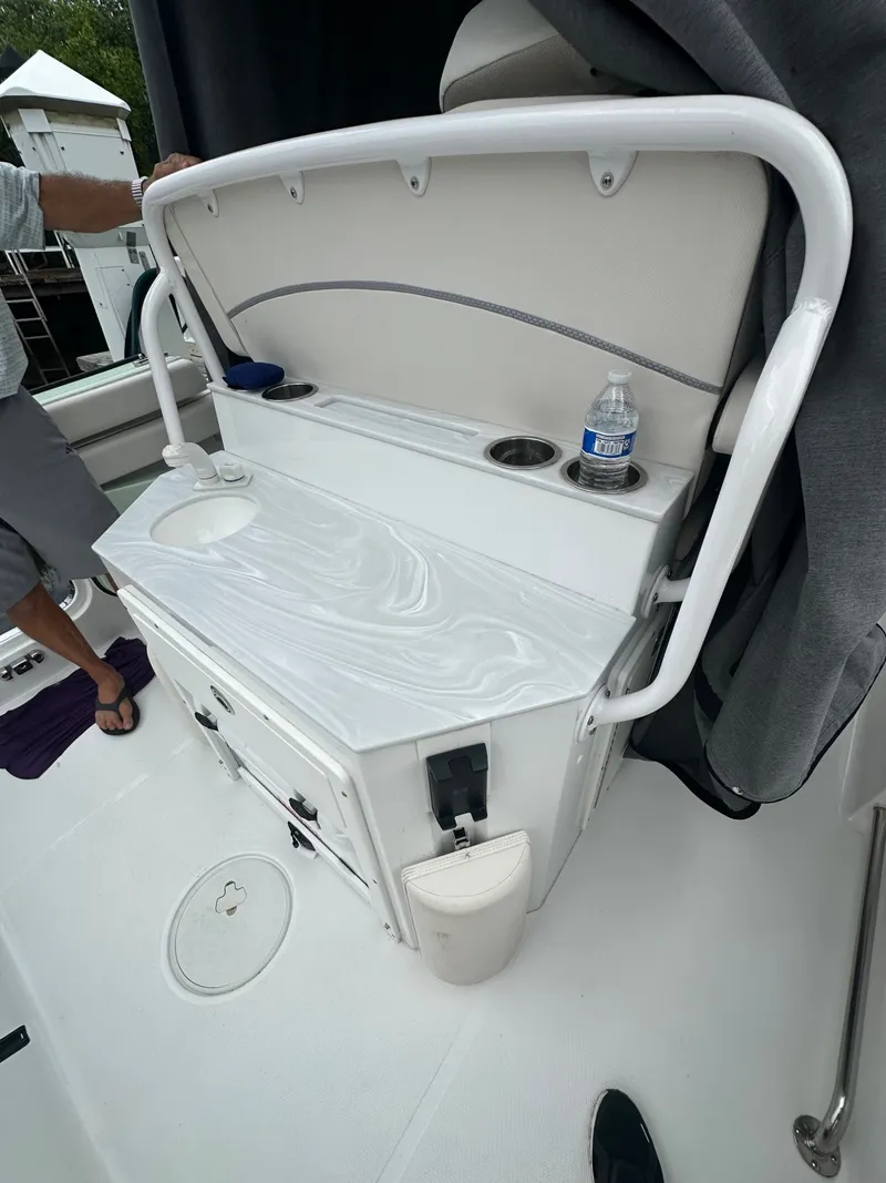 Slide: The Image of The image shows a white boat console with a sink, cup holders, and storage space. - 5