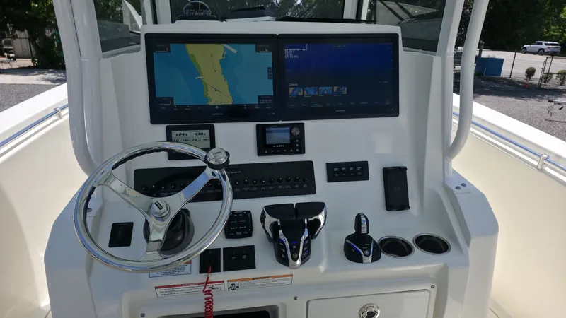 Slide: The Image of The image shows the helm of a Cobia 301 Center Console boat with modern navigation systems. - 12