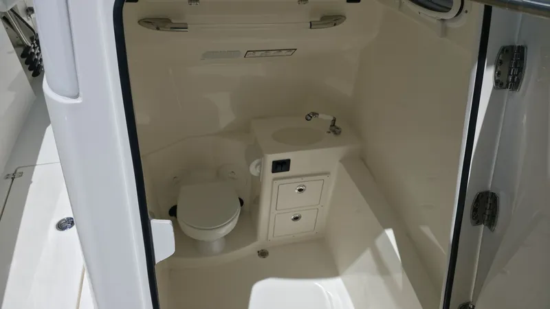 Slide: The Image of The image shows the interior of a boat with a toilet and a sink. - 17