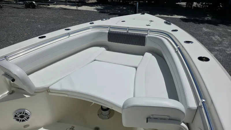 Slide: The Image of The 2025 Cobia 301 Center Console features a spacious, cushioned seating area at the bow. - 15