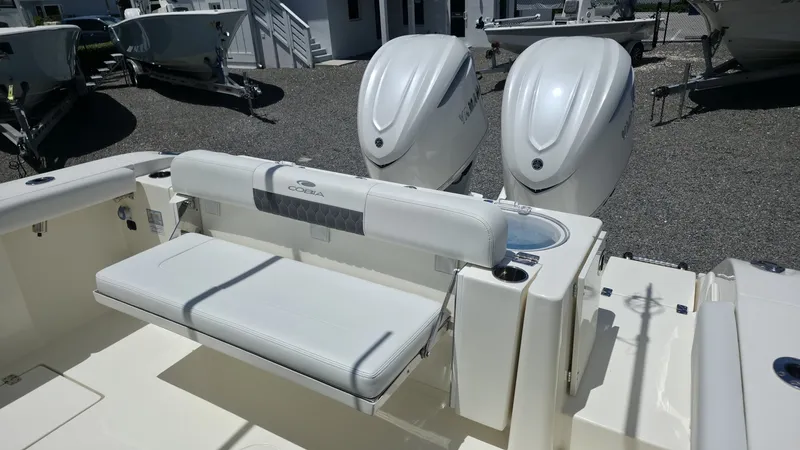 Slide: The Image of The 2025 Cobia 301 Center Console features a spacious bench seat and two powerful outboard engines. - 6