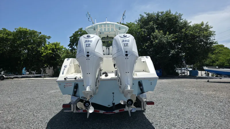 Slide: The Image of The image shows a 2025 Cobia 301 Center Console boat with two powerful outboard engines. - 4