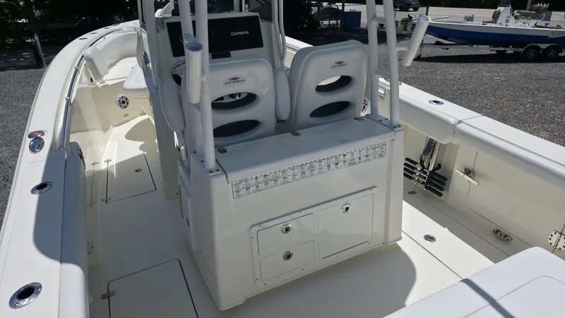 Slide: The Image of The image shows the cockpit of a 2025 Cobia 301 Center Console boat with modern seating and controls. - 7