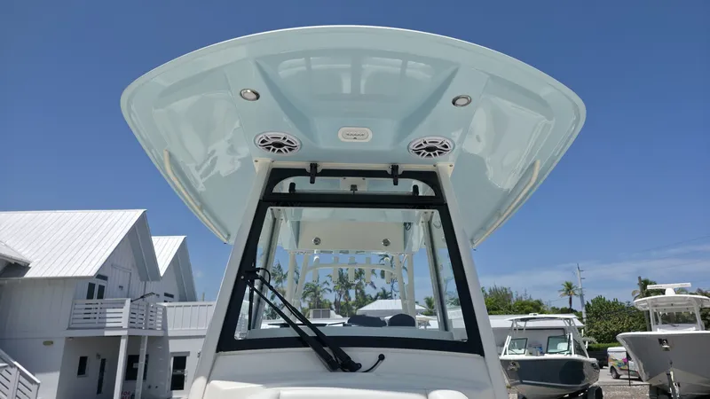 Slide: The Image of The image shows the hardtop of a 2025 Cobia 301 Center Console boat with speakers. - 14