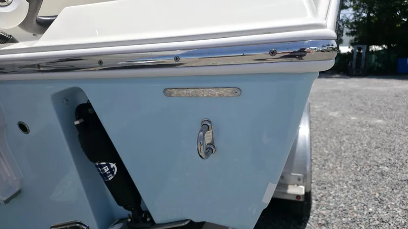 Slide: The Image of Close-up of the stern of a 2025 Cobia 301 Center Console boat, featuring blue paint and stainless steel fittings. - 5