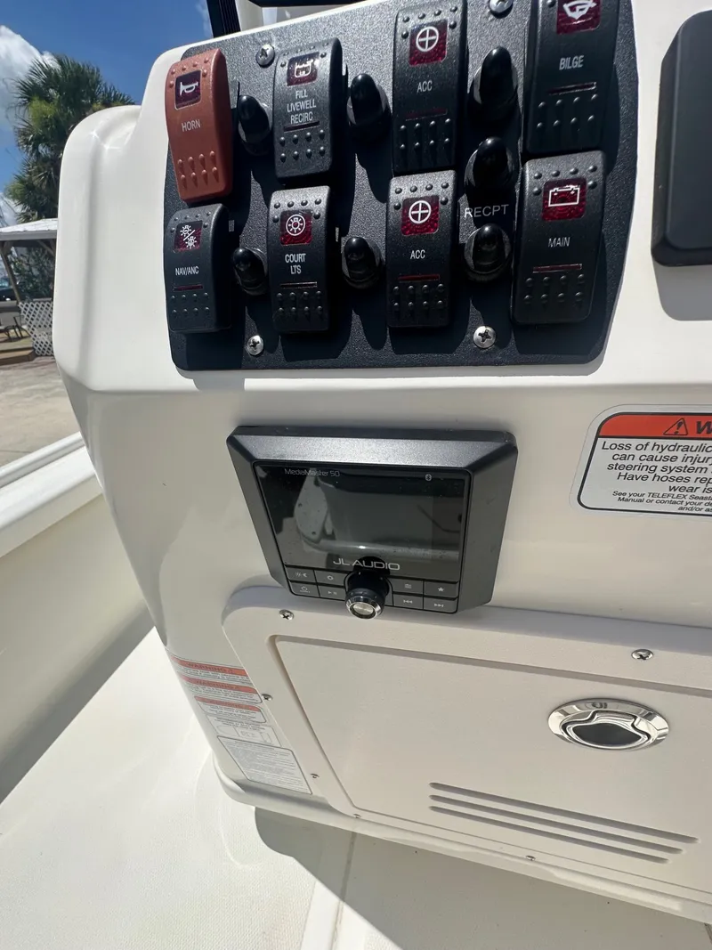 Slide: The Image of The image shows the dashboard of a Mako 18 LTS boat with various switches and a JL Audio system. - 15