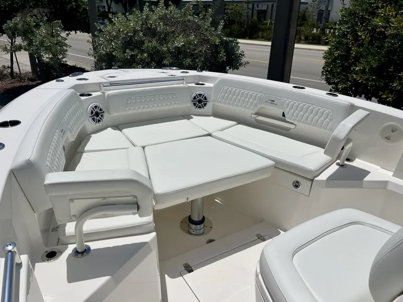 Slide: The Image of The 2027 Cobia 265 Center Console features a luxurious, cushioned seating area at the bow. - 28