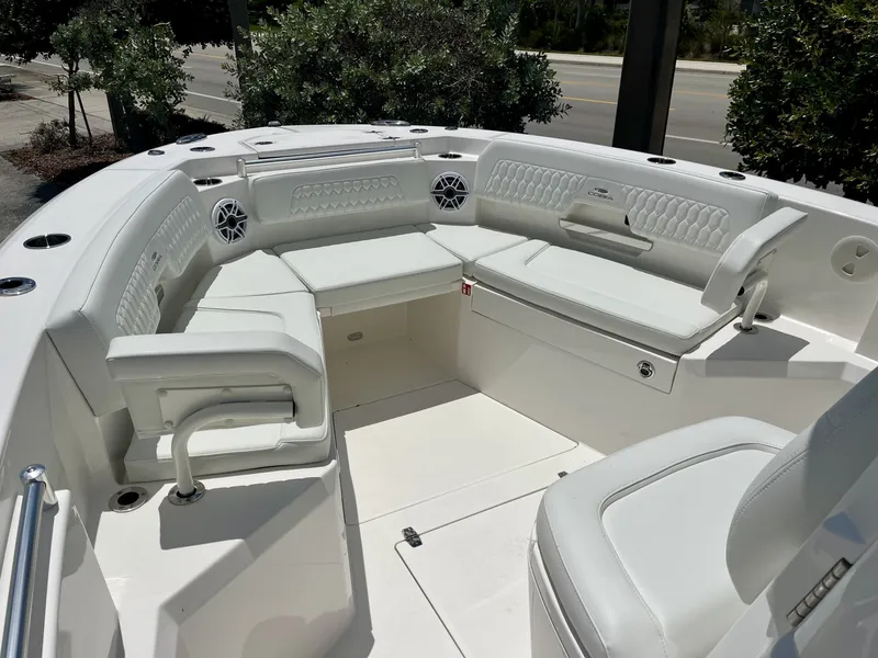 Slide: The Image of The image shows the bow area of a Cobia 265 Center Console boat with white cushioned seating. - 24