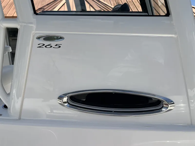 Slide: The Image of Close-up of a white boat with an oval window and "265" marking. - 33