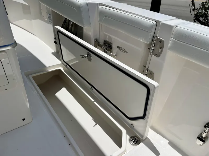 Slide: The Image of The 2027 Cobia 265 Center Console features an open storage compartment with a white interior. - 40
