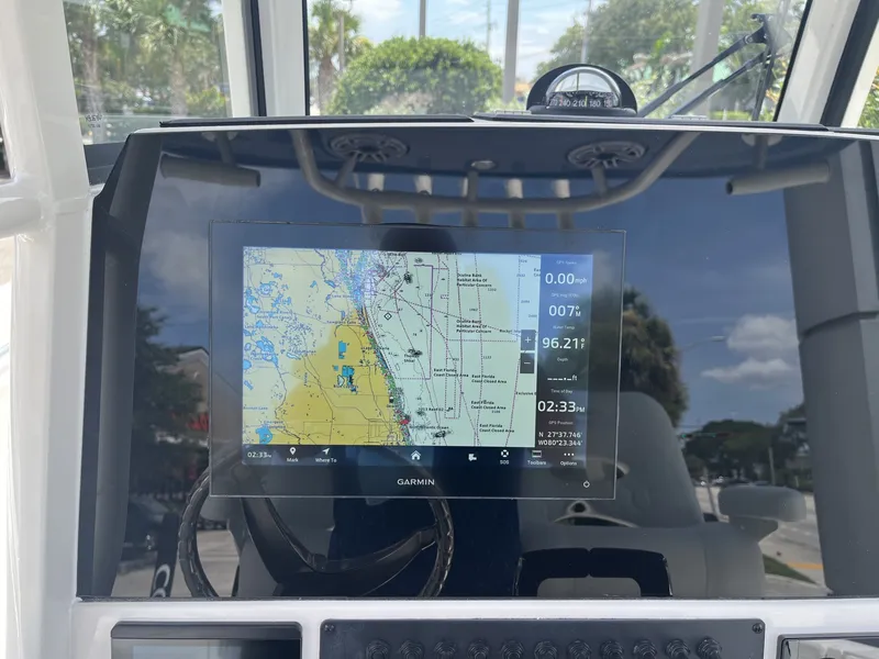 Slide: The Image of The image shows the dashboard of a Cobia 265 Center Console boat with a Garmin navigation system. - 20
