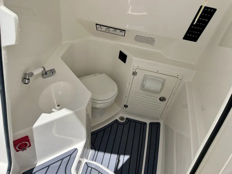 Slide: The Image of The image shows a boat bathroom interior with a toilet, sink, and storage space. - 31