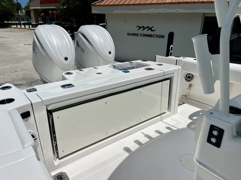 Slide: The Image of The image shows the stern of a Cobia 265 Center Console boat with two outboard engines. - 35