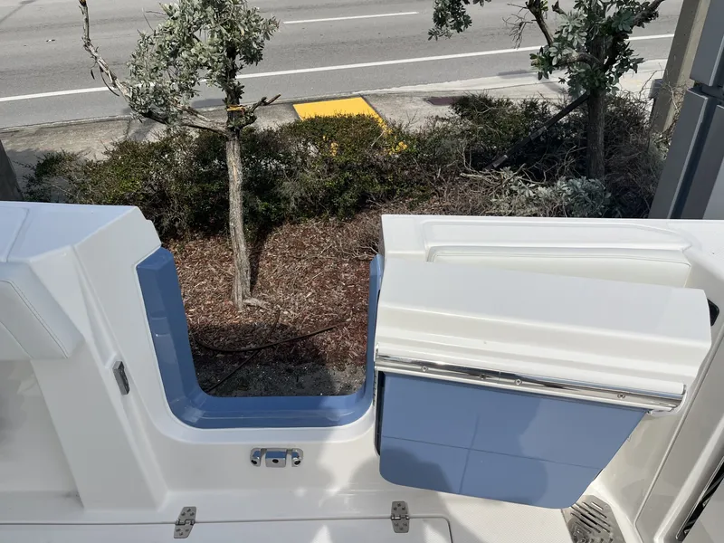 Slide: The Image of The 2027 Cobia 265 Center Console features an open door with blue storage space. - 15