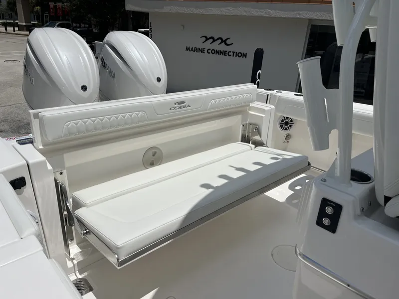 Slide: The Image of The 2027 Cobia 265 Center Console features a white bench seat and two outboard engines. - 37