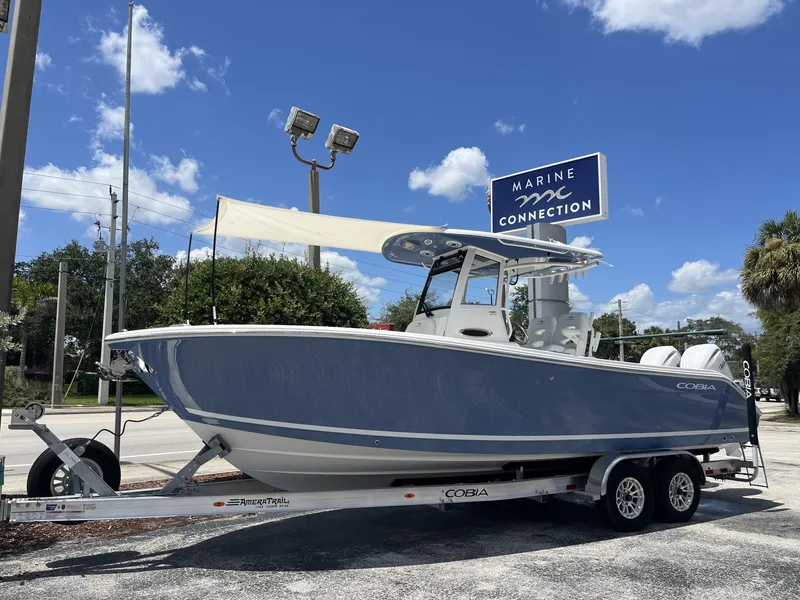 Slide: The Image of A 2027 Cobia 265 Center Console boat on a trailer in a parking lot. - 41