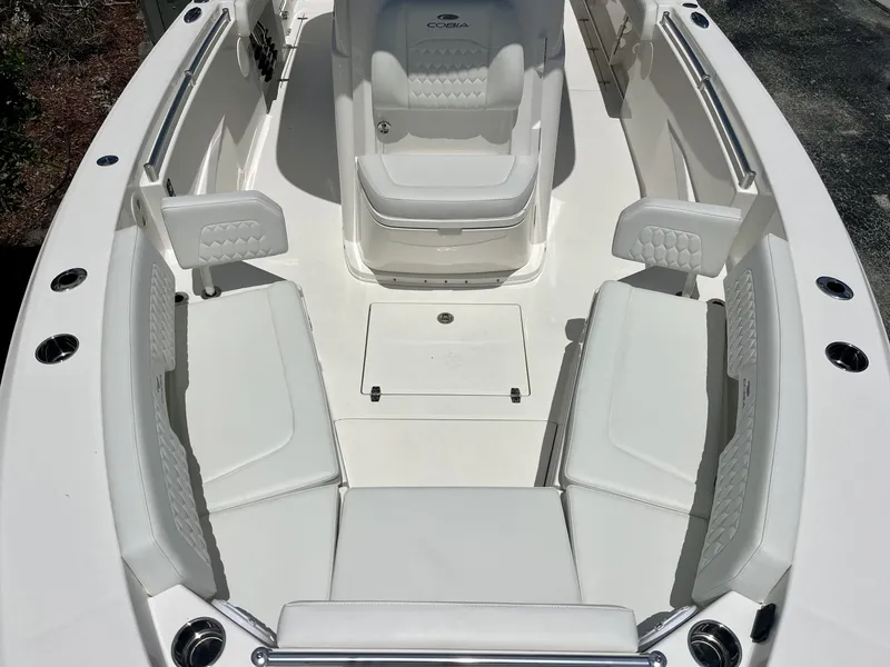 Slide: The Image of The 2027 Cobia 265 Center Console features a spacious, sleek deck with cushioned seating. - 26
