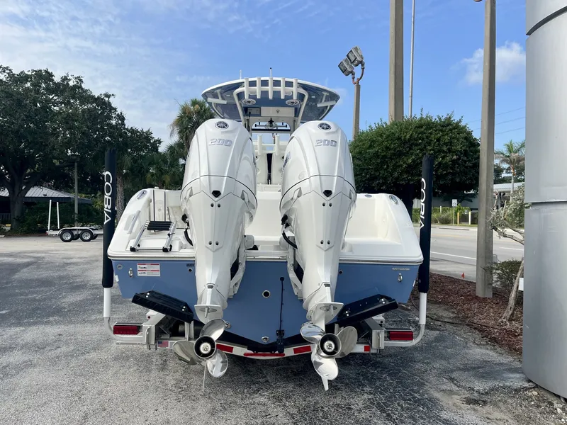 Slide: The Image of The image shows a 2027 Cobia 265 Center Console boat with twin outboard engines. - 5