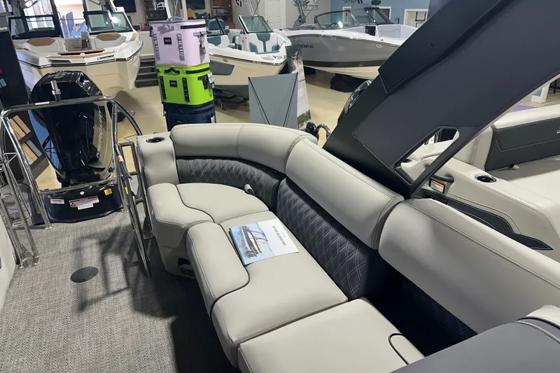 Slide: The Image of 2025 Barletta LUSSO 23QSSA luxury boat interior with plush seating in showroom. - 8