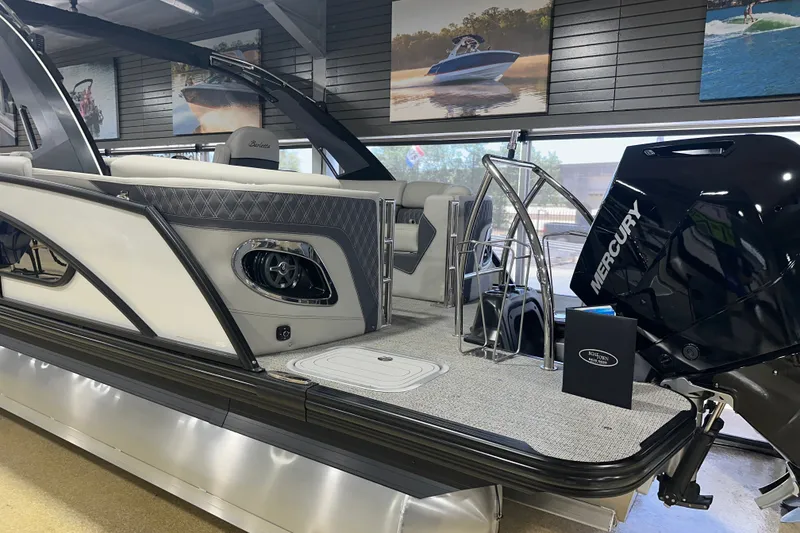 Slide: The Image of 2025 Barletta LUSSO 23QSSA pontoon boat with Mercury engine in showroom. - 2