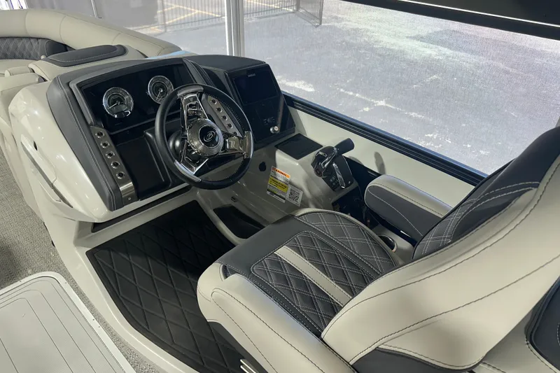 Slide: The Image of Interior of 2025 Barletta LUSSO 23QSSA boat, featuring luxurious steering console and seating. - 10