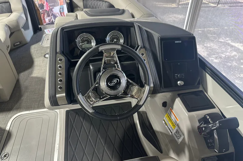Slide: The Image of 2025 Barletta LUSSO 23QSSA boat dashboard with steering wheel and control panel. - 11