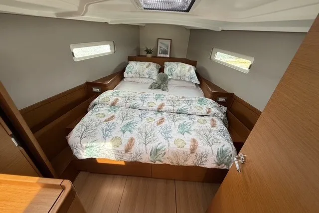 Slide: The Image of Cozy cabin interior of 2022 Jeanneau Sun Odyssey 410 sailboat with double bed. - 45