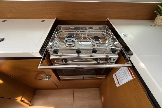 Slide: The Image of Modern kitchen in 2022 Jeanneau Sun Odyssey 410 yacht with stainless steel stove. - 41