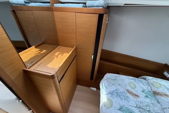 Slide: The Image of Interior of 2022 Jeanneau Sun Odyssey 410 yacht with wooden cabinetry and bed. - 47