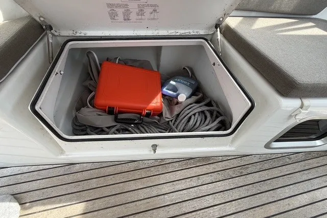 Slide: The Image of Storage compartment on Jeanneau Sun Odyssey 410 yacht with rope, red case, and bottle. - 18